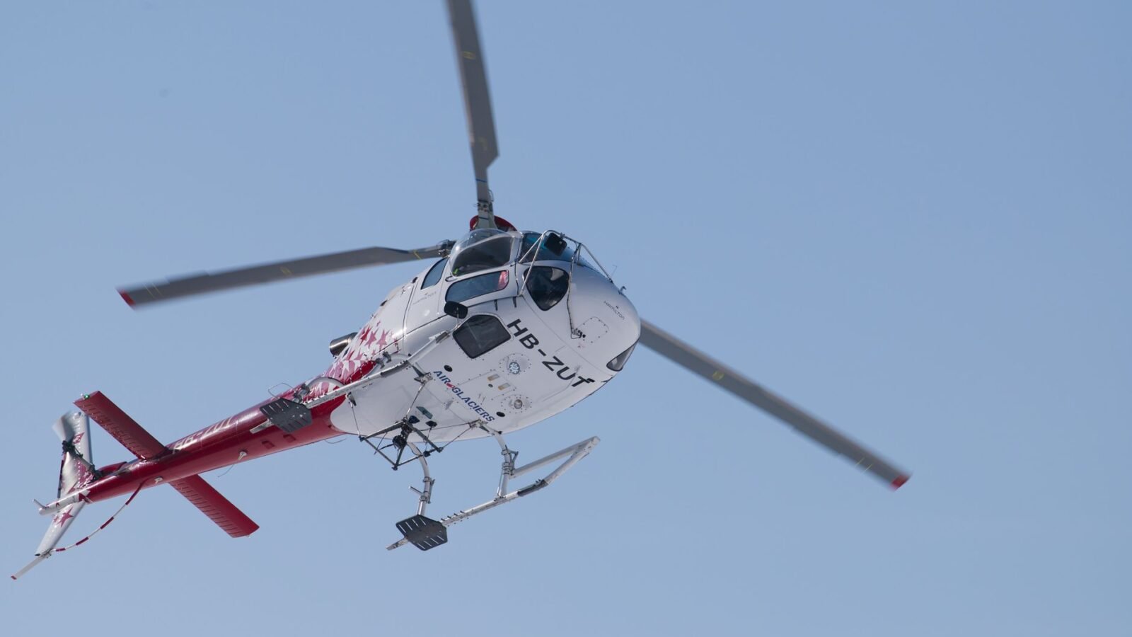 Helicopter in flight over remote terrain symbolising aviation operations
